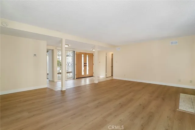 a living room with furniture a large window and a flat screen tv
