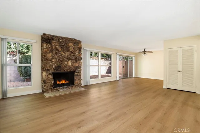a view of a livingroom with wooden floor and a fireplace