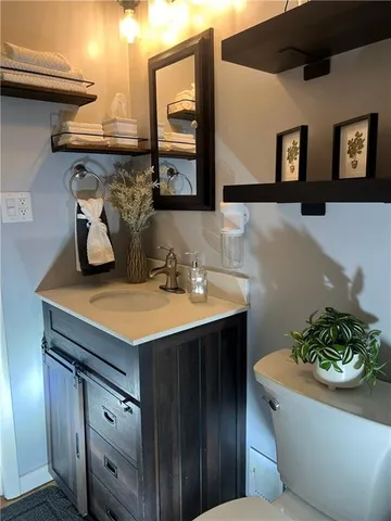 a bathroom with a sink a mirror and vanity
