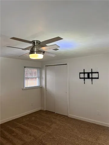 an empty room with a window and wooden floor