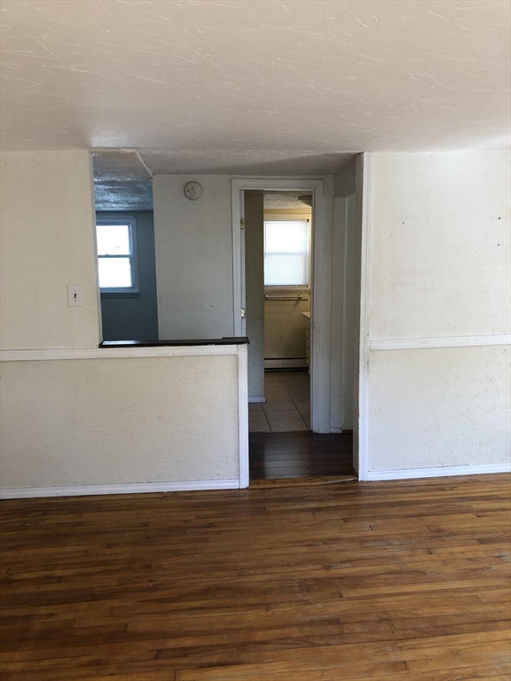 92-94 Sargent Street Leicester, MA 01611 - Photo 13 of 25 a view of an empty room with wooden floor and a window