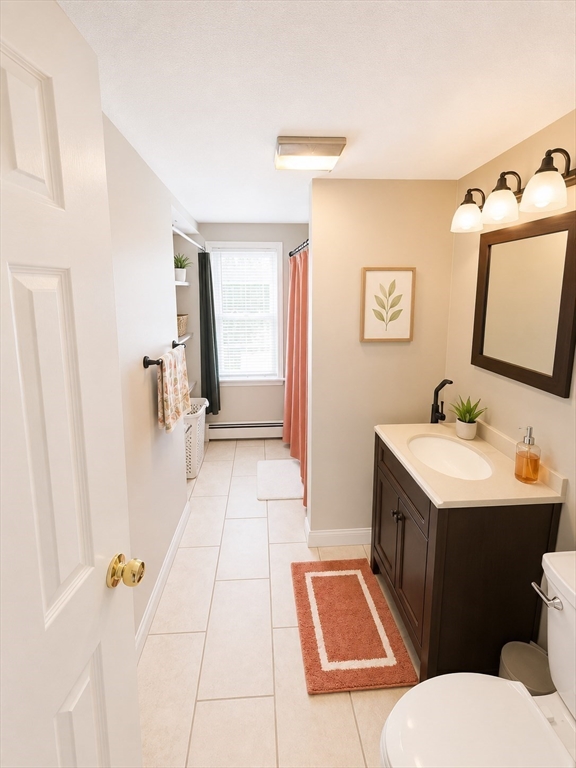 92-94 Sargent Street Leicester, MA 01611 - Photo 20 of 25 a bathroom with a sink and mirror with toilet