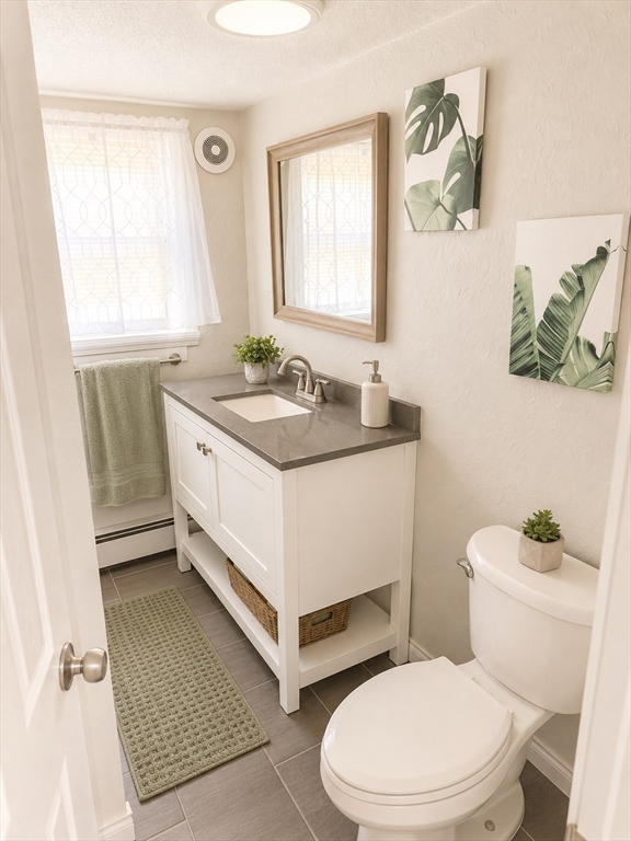 92-94 Sargent Street Leicester, MA 01611 - Photo 8 of 25 a bathroom with a sink a toilet and a window