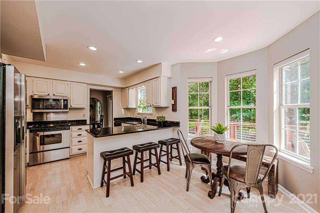 10722 Fairway Ridge Road Charlotte, NC 28277 - Photo 16 of 44 a view of a dining room with furniture window and outside view