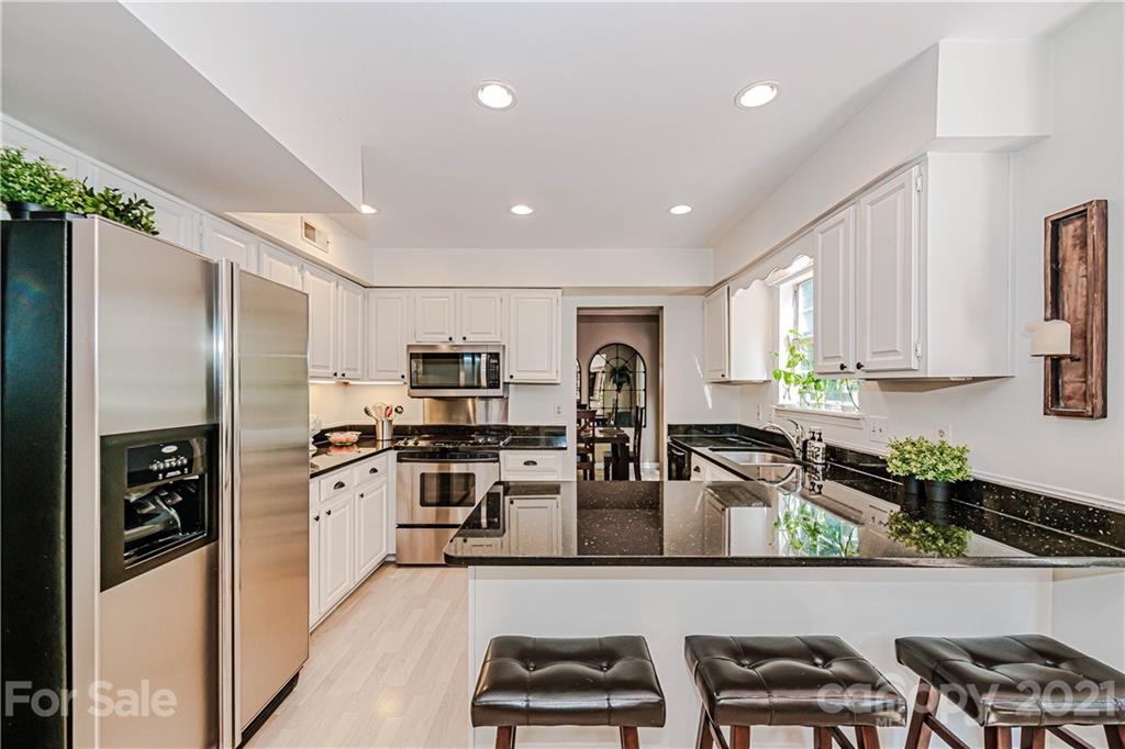 10722 Fairway Ridge Road Charlotte, NC 28277 - Photo 17 of 44 a kitchen with stainless steel appliances granite countertop a refrigerator sink and stove