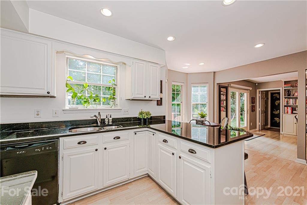10722 Fairway Ridge Road Charlotte, NC 28277 - Photo 20 of 44 a kitchen with granite countertop a sink and white cabinets