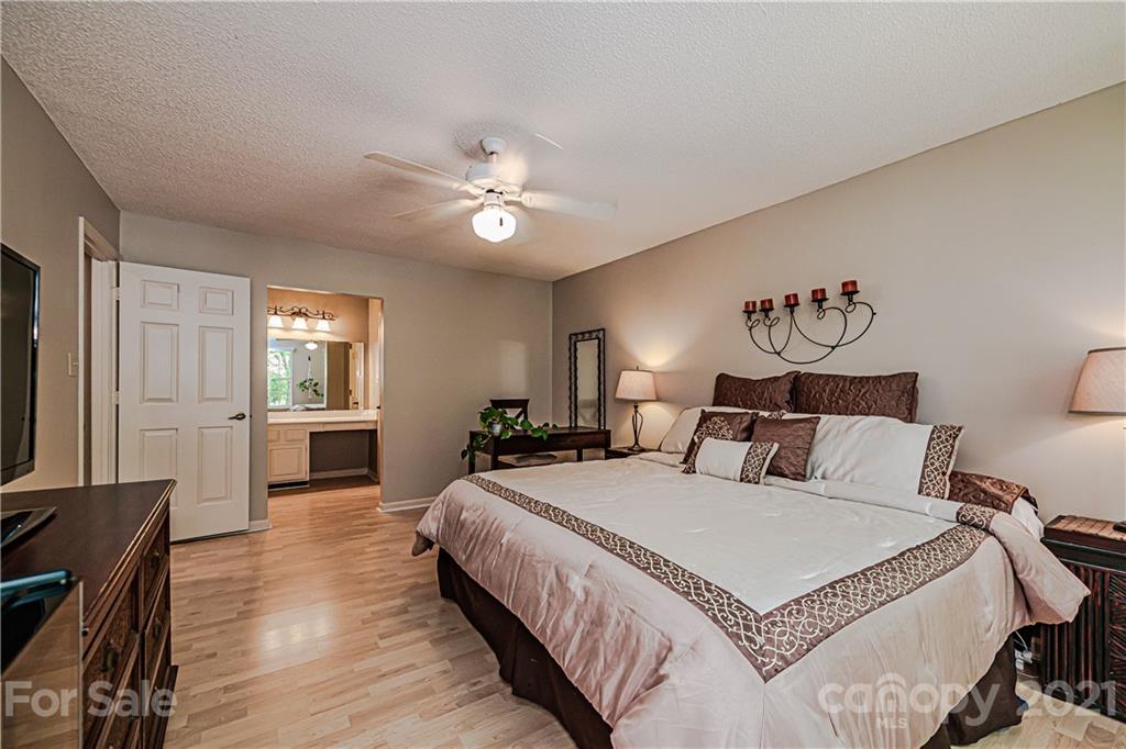 10722 Fairway Ridge Road Charlotte, NC 28277 - Photo 27 of 44 a spacious bedroom with a bed a window and dresser
