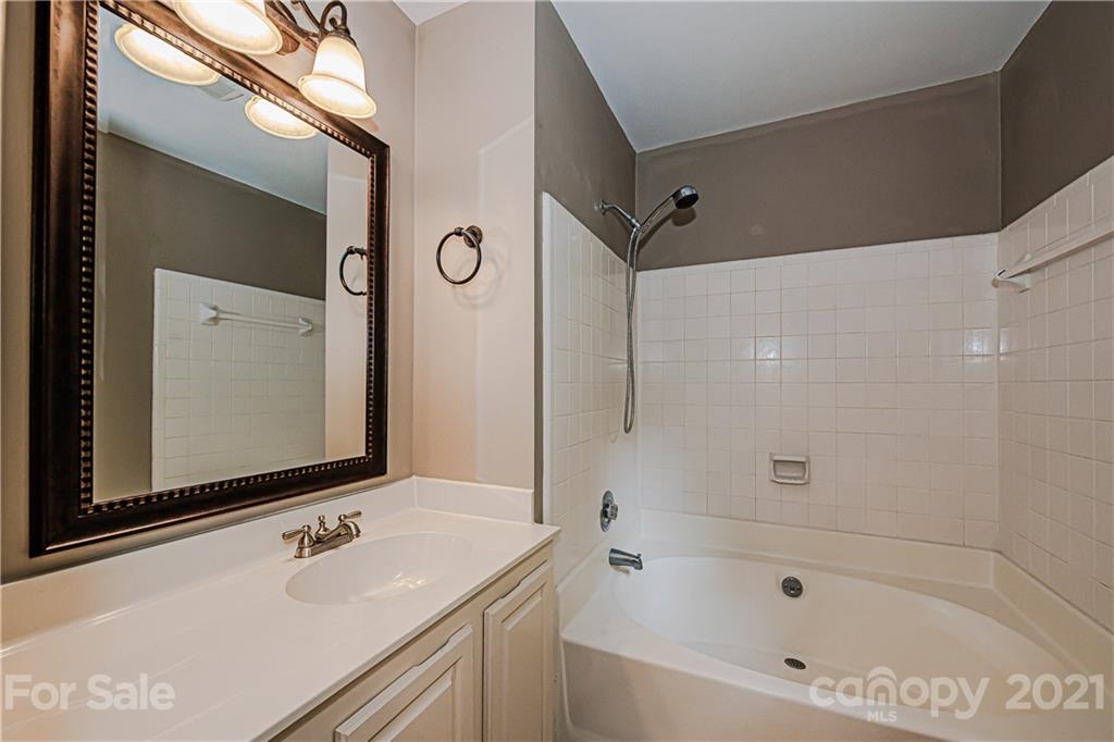 10722 Fairway Ridge Road Charlotte, NC 28277 - Photo 29 of 44 a bathroom with a tub sink and mirror