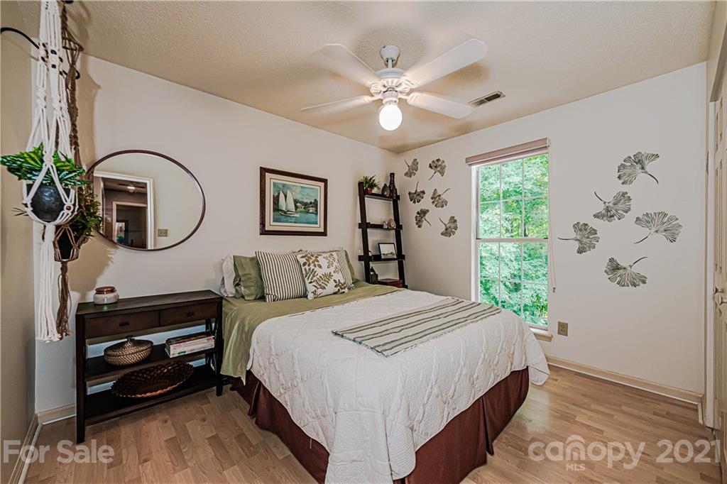10722 Fairway Ridge Road Charlotte, NC 28277 - Photo 33 of 44 a bedroom with a bed a dresser and potted plants