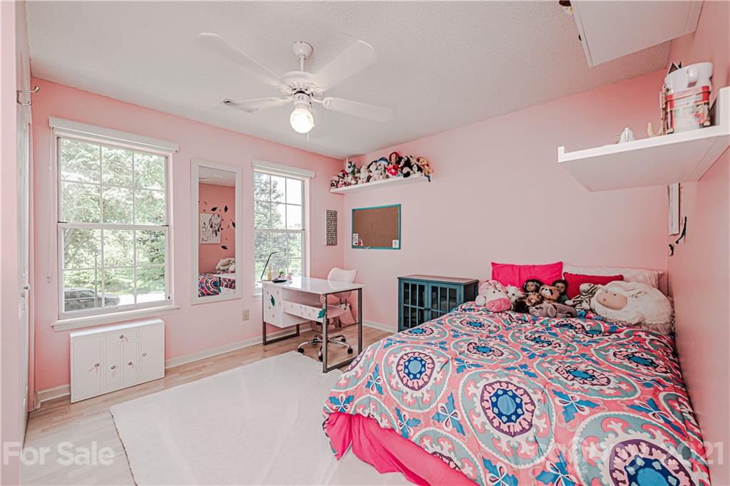 10722 Fairway Ridge Road Charlotte, NC 28277 - Photo 34 of 44 a living room with a bed furniture and a window