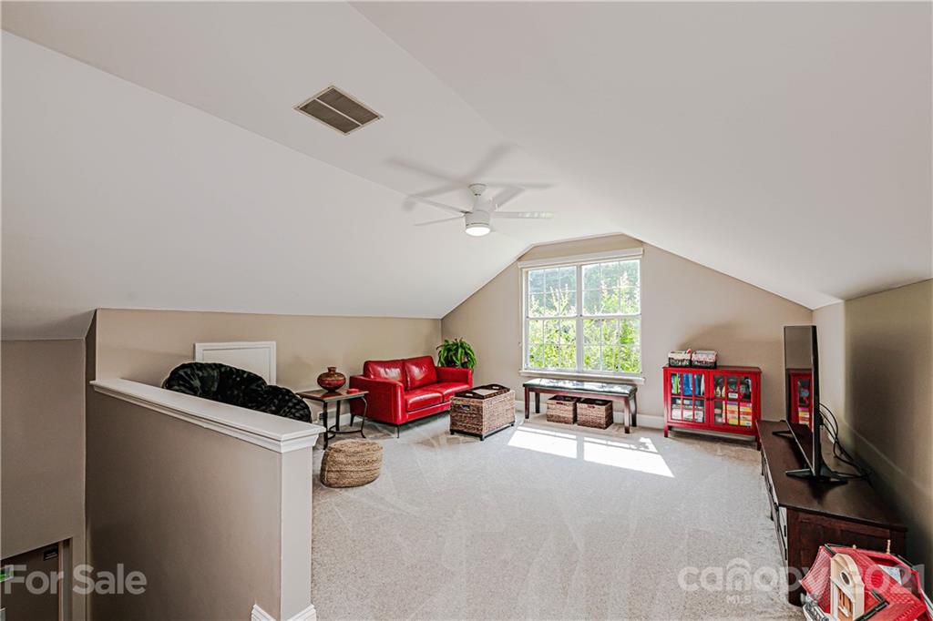10722 Fairway Ridge Road Charlotte, NC 28277 - Photo 35 of 44 a living room with furniture gym equipment and a window