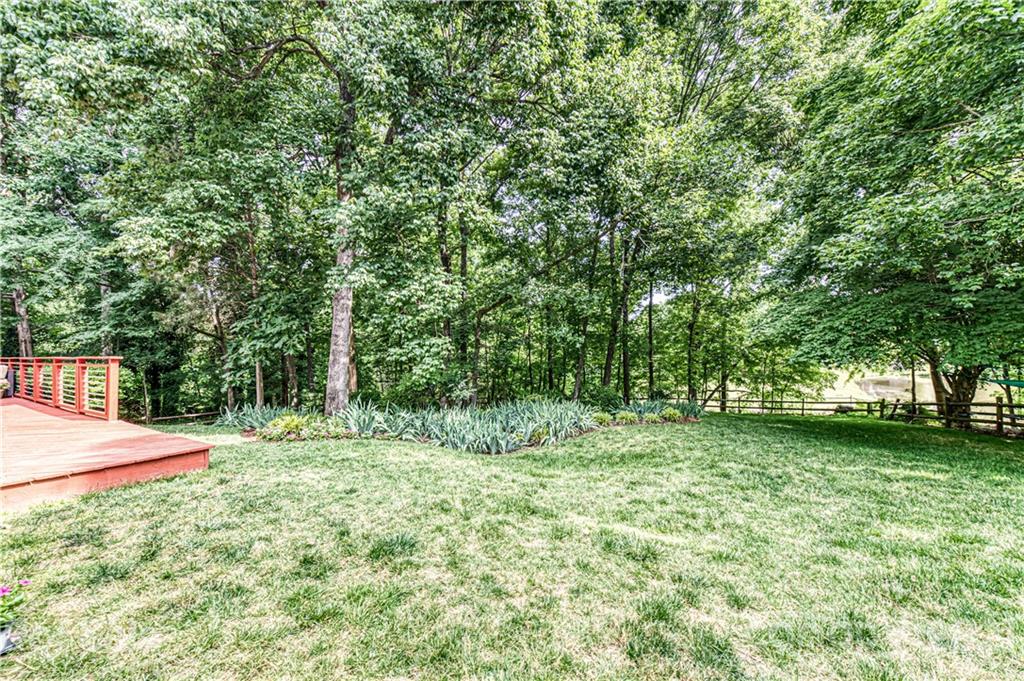 10722 Fairway Ridge Road Charlotte, NC 28277 - Photo 39 of 44 a backyard of a house with lots of green space