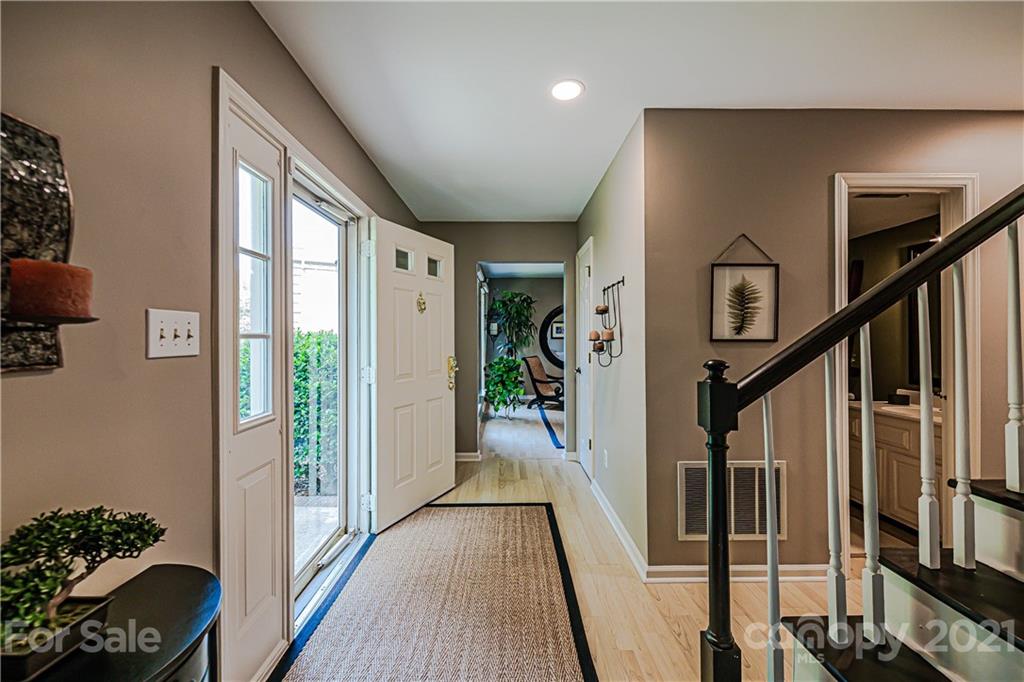10722 Fairway Ridge Road Charlotte, NC 28277 - Photo 6 of 44 a view of a hallway with wooden floor and stairs