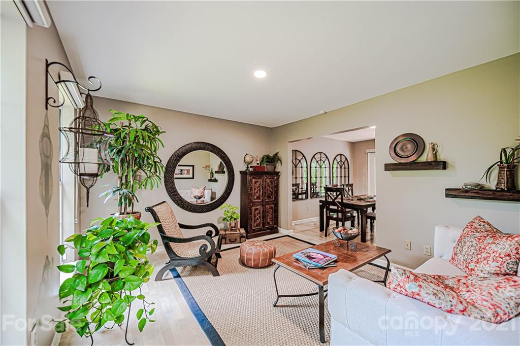 10722 Fairway Ridge Road Charlotte, NC 28277 - Photo 7 of 44 a living room with furniture a rug and a potted plant