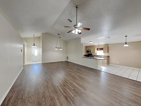 a view of a kitchen with a stove cabinets and wooden floor