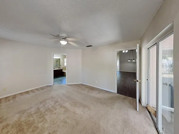 an empty room with closet and windows