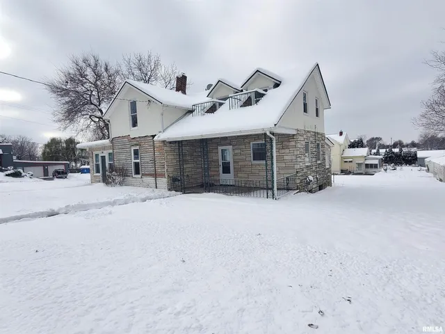 a view of a house with a snow in the yard