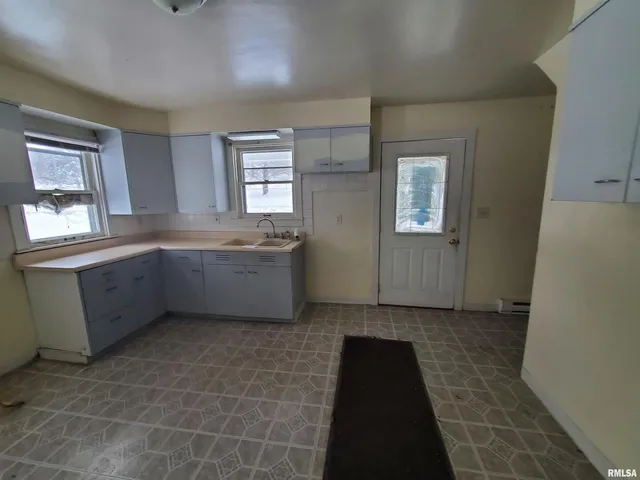 a view of a kitchen with a sink cabinet and a window