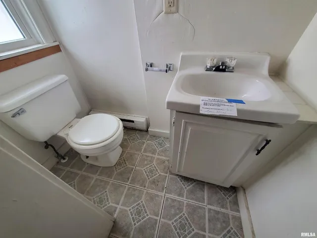 a bathroom with a sink toilet and vanity