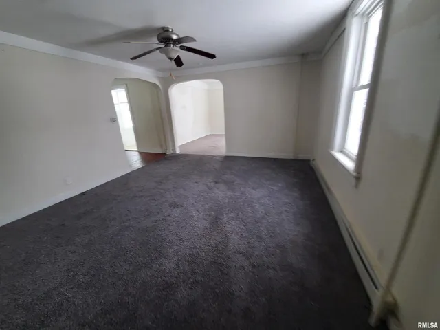 a view of empty room with ceiling fan
