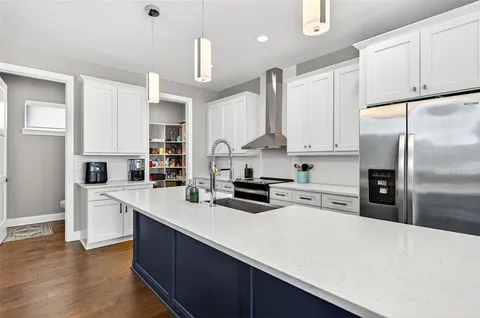 a kitchen with stainless steel appliances a refrigerator sink and cabinets