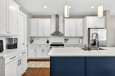a kitchen with appliances a sink and cabinets
