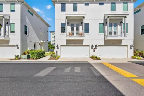 a front view of a house with a yard and a garage