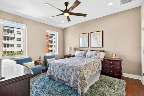 a bedroom with a bed a couch and a window