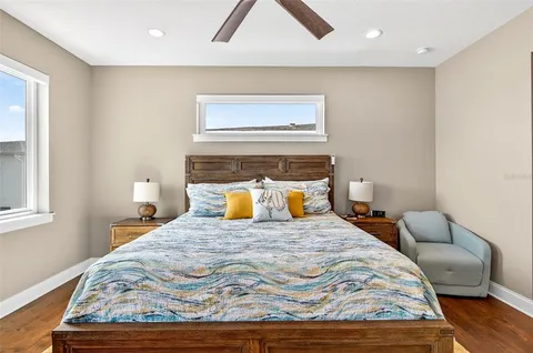 a bedroom with a bed and wooden floor