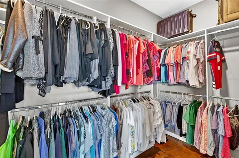 a view of walk in closet with clothes