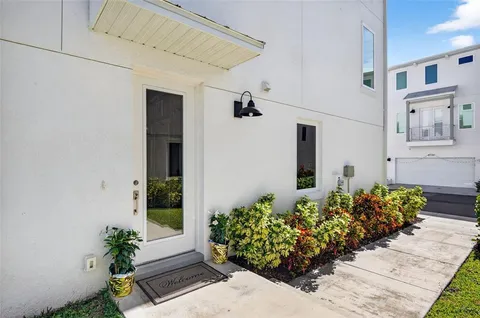 a front view of a house with flowers
