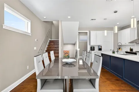 a dining room with furniture and wooden floor