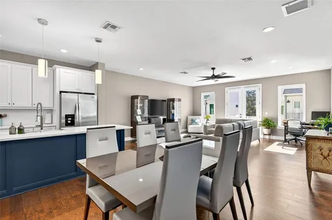 a large kitchen with a table and chairs