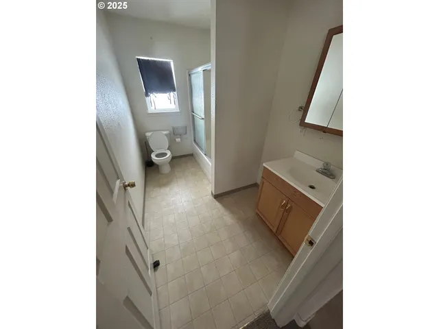 a view of a kitchen from a hallway