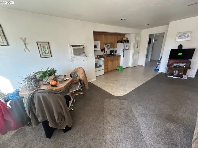 a view of a livingroom with furniture and a flat screen tv