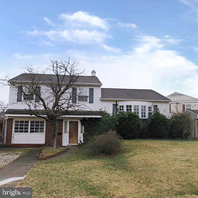 718 Mayo Road Glen Burnie, MD 21061 - Photo 2 of 48 Charming home with lush greenery and sky.