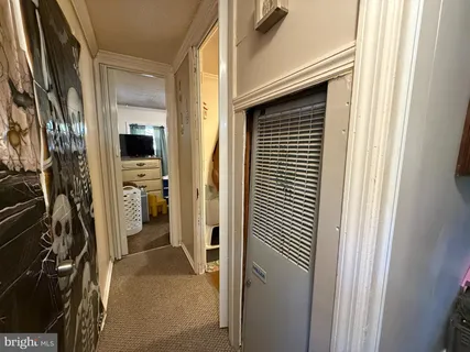 a view of a hallway with a livingroom