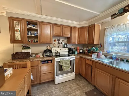 a kitchen with a stove top oven sink and cabinets