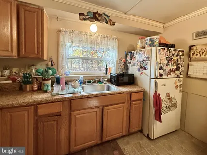 a kitchen with refrigerator and window
