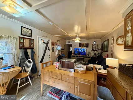 a room with furniture a flat screen tv and a table