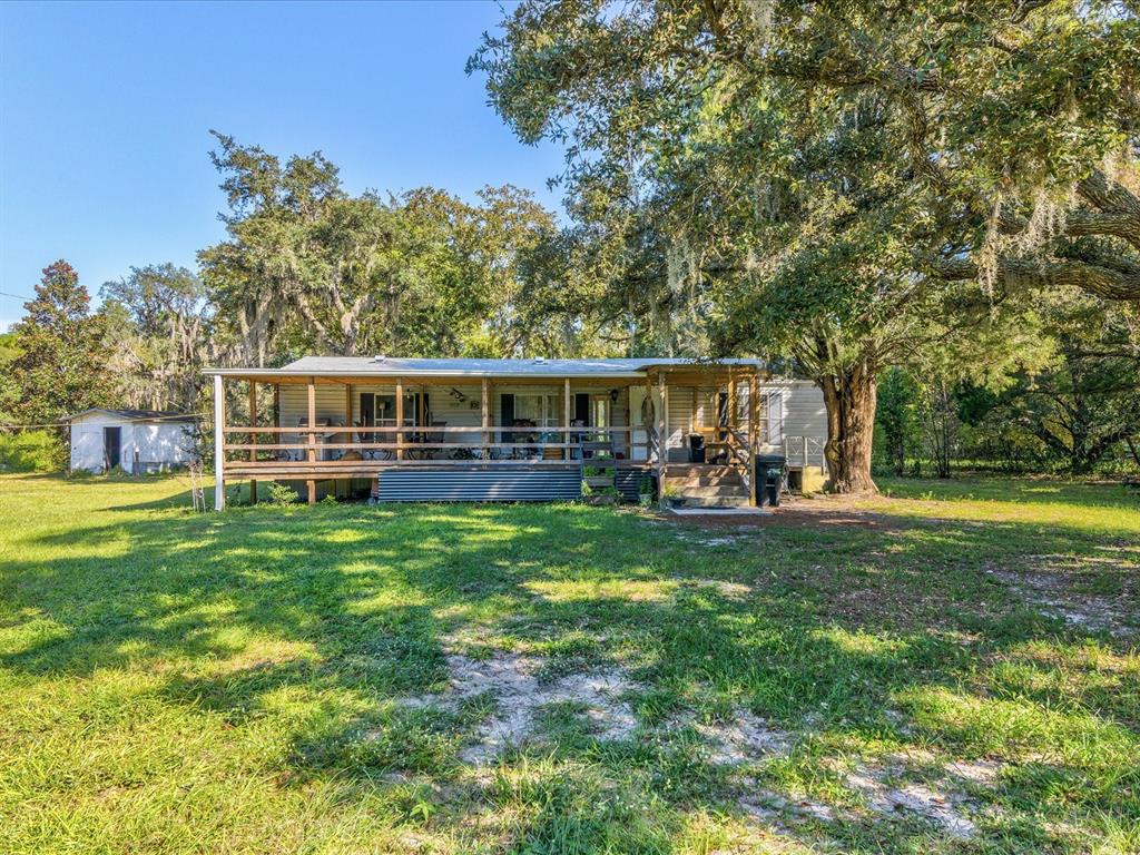 15145 Lancer Road Spring Hill, FL 34610 - Photo 1 of 1 front view of a house with a big yard