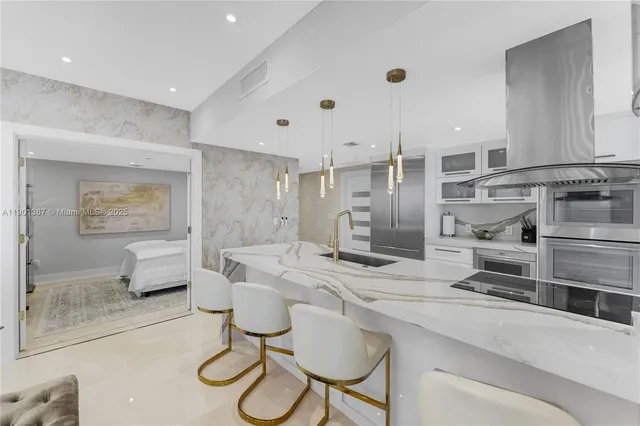 a kitchen with stainless steel appliances kitchen island granite countertop a sink and cabinets