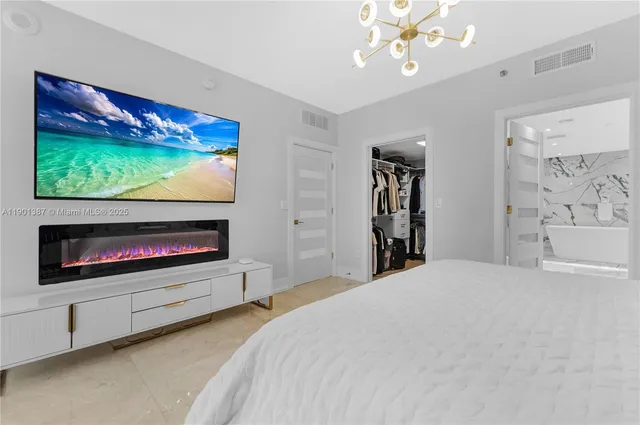 a bedroom with a bed and a flat screen tv