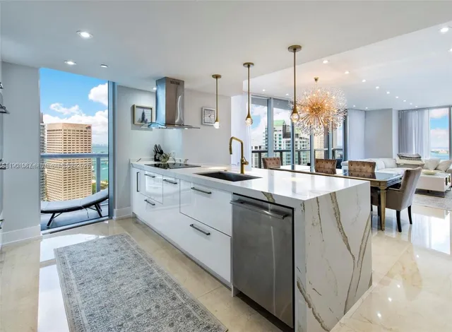 a kitchen with stainless steel appliances kitchen island granite countertop a sink a counter top space and cabinets