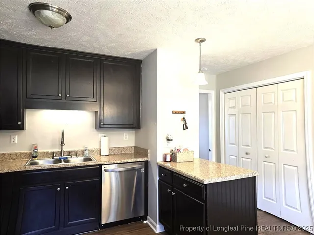 a kitchen with stainless steel appliances granite countertop a sink stove and cabinets