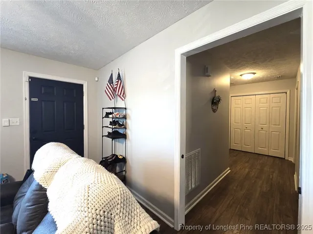 a view of a livingroom with furniture and closet