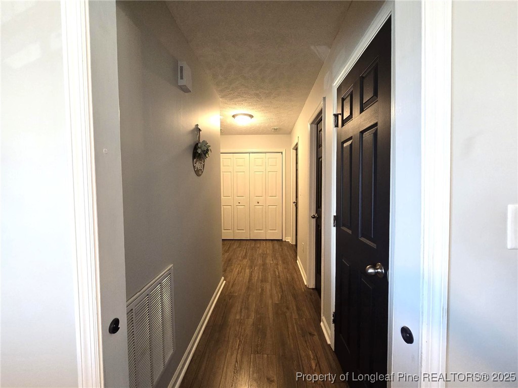 5345 Pittman Grove Church Road Raeford, NC 28376 - Photo 20 of 45 a view of a hallway with wooden floor