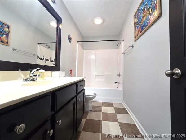 a bathroom with a double vanity sink toilet and shower