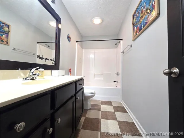 a bathroom with a double vanity sink toilet and shower