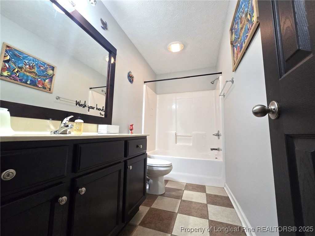 5345 Pittman Grove Church Road Raeford, NC 28376 - Photo 22 of 45 a bathroom with a sink a toilet a shower and a mirror